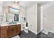 Bathroom featuring a custom sink, toilet, and tiled walk-in shower at 4453 Buffalo Shoals Rd, Maiden, NC 28650