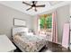Cozy bedroom with a floral comforter, wood floors, and a bright window view at 4453 Buffalo Shoals Rd, Maiden, NC 28650