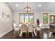 Elegant dining room with large windows offering scenic views, complemented by a stylish chandelier and seating for six at 4453 Buffalo Shoals Rd, Maiden, NC 28650