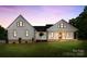 Charming exterior of a two-story home with a well-manicured lawn and inviting front porch with rocking chairs at 4453 Buffalo Shoals Rd, Maiden, NC 28650