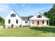 Exterior view of a two-story home with white siding, black trim, and a welcoming front porch with rocking chairs at 4453 Buffalo Shoals Rd, Maiden, NC 28650
