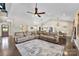 Bright, open living area with hardwood floors, a large sectional sofa, and easy access to the kitchen and dining areas at 4453 Buffalo Shoals Rd, Maiden, NC 28650