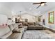 Inviting living room featuring a large sectional sofa, ceiling fan, and an open floor plan to the kitchen at 4453 Buffalo Shoals Rd, Maiden, NC 28650