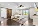 Serene main bedroom boasts a large bed, barn door leading to the bathroom, and bright windows for natural light at 4453 Buffalo Shoals Rd, Maiden, NC 28650