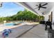Covered patio overlooking the pool and backyard with outdoor seating and a grill at 4453 Buffalo Shoals Rd, Maiden, NC 28650