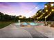 Beautiful pool and spa area with a brick patio and string lights at dusk at 4453 Buffalo Shoals Rd, Maiden, NC 28650