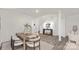 Dining area with modern table, chairs, and stylish decor, leading to entryway and living space at 448 Berryman Rd, Rock Hill, SC 29732