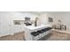 Open kitchen featuring a large island with seating, white cabinets, and stainless steel appliances at 448 Berryman Rd, Rock Hill, SC 29732