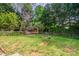 Lush backyard featuring a wooden pergola and a quaint garden, perfect for outdoor relaxation at 4501 Bainview Dr, Mint Hill, NC 28227