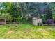Expansive backyard featuring a charming shed and wooden fence, offering privacy and storage at 4501 Bainview Dr, Mint Hill, NC 28227