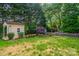 Well-maintained backyard showcasing a shed, vibrant landscaping, and privacy fencing at 4501 Bainview Dr, Mint Hill, NC 28227