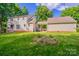 Backyard featuring garden, deck and attached garage with covered walkway at 4501 Bainview Dr, Mint Hill, NC 28227