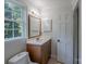 Well-lit bathroom with modern vanity, mirror, and fixtures at 4501 Bainview Dr, Mint Hill, NC 28227