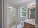 Bathroom with glass enclosed shower and modern vanity, with a view of the outside at 4501 Bainview Dr, Mint Hill, NC 28227