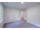 A cozy bedroom with gray carpet and two doors, one possibly leading to a closet at 4501 Bainview Dr, Mint Hill, NC 28227
