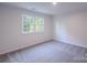 Comfortable bedroom with soft carpeting and a large window, creating a relaxing atmosphere at 4501 Bainview Dr, Mint Hill, NC 28227