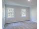 Cozy bedroom with soft carpet, two windows providing scenic views and natural lighting at 4501 Bainview Dr, Mint Hill, NC 28227