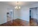 Bright dining room with wood floors and decorative trim, adjacent to an open kitchen at 4501 Bainview Dr, Mint Hill, NC 28227
