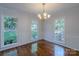 Bright dining room featuring hardwood floors, large windows, with trim at 4501 Bainview Dr, Mint Hill, NC 28227