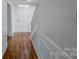 Welcoming entryway featuring hardwood floors, white wainscoting, and a bright front door at 4501 Bainview Dr, Mint Hill, NC 28227