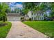 Two-story home with attached garage, showcasing the long driveway and well-maintained lawn at 4501 Bainview Dr, Mint Hill, NC 28227