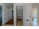 Hallway with closet, light tile floors, and trim, with views to living spaces at 4501 Bainview Dr, Mint Hill, NC 28227