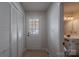 Hallway with closet, glass door, light tile floors, and a half bath at 4501 Bainview Dr, Mint Hill, NC 28227