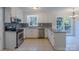 Well-lit kitchen with stainless steel appliances, granite countertops, and tiled backsplash at 4501 Bainview Dr, Mint Hill, NC 28227