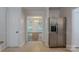Bright kitchen with stainless steel refrigerator, tile flooring, and doorway to the dining room at 4501 Bainview Dr, Mint Hill, NC 28227