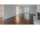 Bright living room showcasing hardwood floors, fireplace and french doors to backyard at 4501 Bainview Dr, Mint Hill, NC 28227