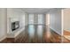 Bright living room showcasing hardwood floors, fireplace and built-in shelving at 4501 Bainview Dr, Mint Hill, NC 28227