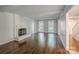 Spacious living room with hardwood floors, a fireplace, built-in shelves and natural light at 4501 Bainview Dr, Mint Hill, NC 28227