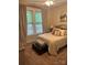 Cozy bedroom with natural light and features a dresser, chest, and view of the outdoor landscape at 4561 N Wynswept N Dr, Maiden, NC 28650