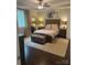 Well-lit bedroom features a king bed, cushioned bench, carpeted floors, and two bedside tables at 4561 N Wynswept N Dr, Maiden, NC 28650