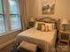 Cozy bedroom with natural light and features a dresser, chest, and view of the outdoor landscape at 4561 N Wynswept N Dr, Maiden, NC 28650