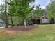Charming single-Gathering home with inviting curb appeal, showcasing a well-maintained lawn and mature trees at 4561 N Wynswept N Dr, Maiden, NC 28650