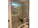 Modern shower with glass doors, tiled walls, bench and natural light, showcasing a spa-like experience at 4561 N Wynswept N Dr, Maiden, NC 28650