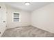 Inviting bedroom with plush gray carpeting, a well-lit window, and a convenient closet on the side at 503 Randa Dr, Statesville, NC 28625