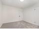 Light-filled bedroom with soft gray carpet, white walls, and a convenient single door closet at 503 Randa Dr, Statesville, NC 28625