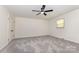 Spacious bedroom with plush gray carpet and ceiling fan at 503 Randa Dr, Statesville, NC 28625