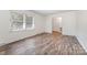 Bright bedroom with wood-look floors, window, and closet at 503 Randa Dr, Statesville, NC 28625