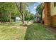 Exterior view of home with a sunroom addition and detached garage in a lush green yard at 503 Randa Dr, Statesville, NC 28625