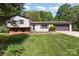 Split-level home boasts a well-maintained lawn, brick accents, and attached two-car garage at 503 Randa Dr, Statesville, NC 28625