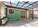 A sunroom with wood floors, glass roof, and a pass-through to the kitchen provides natural light and indoor/outdoor living at 503 Randa Dr, Statesville, NC 28625