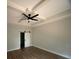 Bedroom with tray ceiling, ceiling fan, and a barn door leading to an adjacent room at 5751 Selkirk Dr, Hickory, NC 28601