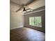Bedroom with decorative tray ceiling, ceiling fan, and a large window at 5751 Selkirk Dr, Hickory, NC 28601