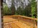 View of a wooden deck overlooking a green backyard with a lush tree line at 5751 Selkirk Dr, Hickory, NC 28601