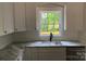 Bright kitchen featuring granite countertops, modern appliances, and white shaker cabinets at 5751 Selkirk Dr, Hickory, NC 28601