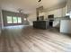 Open-concept living room and kitchen with hardwood floors and modern light fixtures at 5751 Selkirk Dr, Hickory, NC 28601