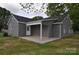 Outdoor patio area featuring gray siding and a well-maintained lawn at 602 Still St # 1 Blk C, Chester, SC 29706
